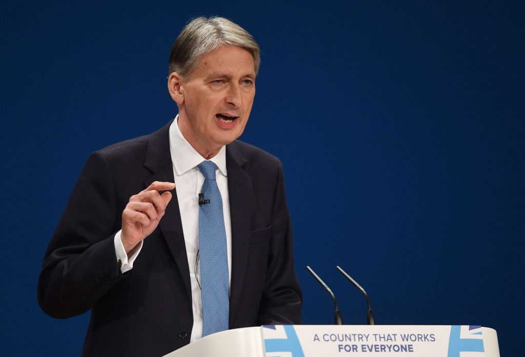Britain's Chancellor of the Exchequer Philip Hammond speaks on the second day of the Conservative party conference in Birmingham, England, Monday Oct. 3, 2016. Philip Hammond told the BBC on Monday that Britain will face a couple of years, or longer, of uncertainty as Britain goes through the process of leaving the 28-nation trading bloc. (Joe Giddens/PA via AP)